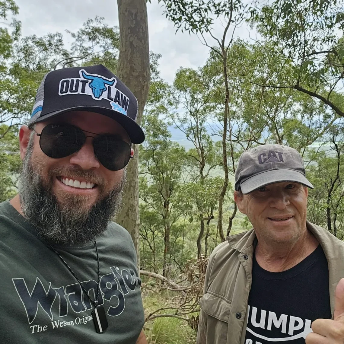 Warren and his Coordinator in the bush giving a thumbs up.
